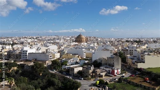 Dense City With Rotunda Of Mosta Dome In Mosta, Malta. Aerial Drone Shot