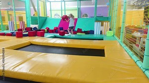 Little girl bouncing on a trampoline in the entertainment center