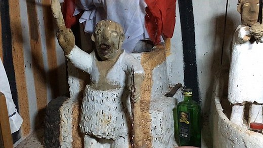 Inside Nigerian Voodoo shrine: Priest pours schnapps over shrine