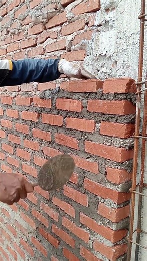The process of installing red bricks with cement and sand mixture