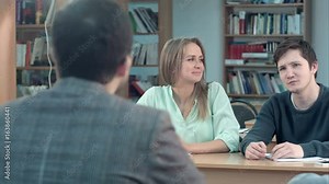 Student sitting at their desks and asking question in a classroom