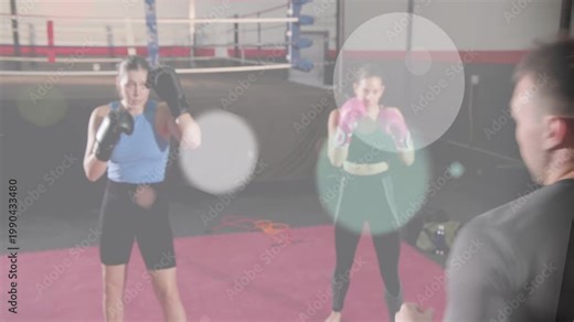 Coach cueing boxing drill raising arms, two women throwing jabs and counters, overlays thinning