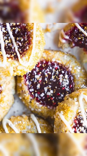 Vegan Raspberry Thumbprint Cookies⭐ https://www.cottercrunch.com/raspberry-thumbprint-cookies-vegan/ A classic Christmas cookie recipe, these Vegan Raspberry Thumbprint Cookies are given a makeover with gluten free ingredients and a hint of amaretto for festive jam-filled cookies everyone will love! | Cotter Crunch - Gluten-Free Recipes & Nutrition