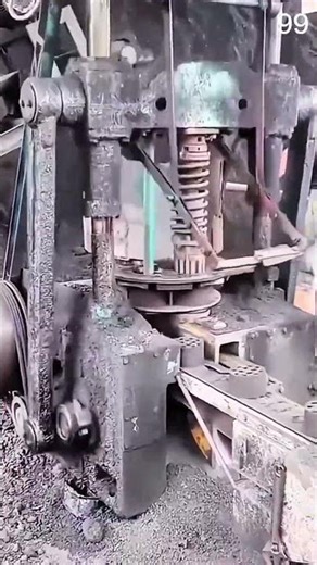 Man operates heavy press in gritty forging workshop