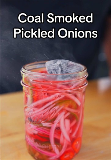 Coal Smoked Pickled Onions!! A technique I tried for the Open Fire MeatUp World Championships and it blew me away! Excited to share it with everyone!! Just make sure before you try this… you use clean and high quality charcoal. I always recommend @Jealous Devil for this! Ingredients for 2 jars: • 2 red onions , thinly sliced pole to pole • 2 jalapeños thinly sliced • 2 Fresno Chiles, thinly sliced • 8 cloves of garlic, crushed • 3 cups water • 1 cup vinegar • 1/3 cup salt • 1/3 cups sugar • 2 tb