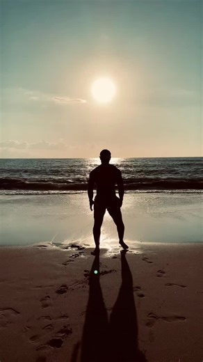 Muscular Bodybuilder Posing on the Beach
