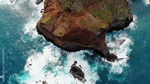 Madeira island, Portugal. Top down aerial view. Beautiful landscape of Madeira island. Brown-green rocks in the ocean - Madeira easternmost point. Portugal Landmarks and landscape from above