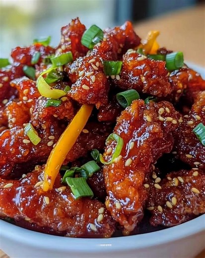 Crispy Sticky Chicken with Sesame and Spring Onions Ingredients: - 2 lbs chicken wings or drumsticks 🍗 - 1/4 cup soy sauce 🍶 - 1/4 cup honey 🍯 - 2 tbsp rice vinegar 🍚 - 2 tbsp sesame oil 🌰 - 3 cloves garlic, minced 🧄 - 1 inch ginger, grated 🥢 - 1 tsp red pepper flakes (optional) 🌶️ - 1/4 cup cornstarch 🌽 - Vegetable oil for frying 🛢️ - 2 tbsp sesame seeds 🌱 - 3 spring onions, chopped 🌿 - Salt and pepper to taste 🧂 Directions: In a large bowl, combine soy sauce, honey, rice vinegar, 