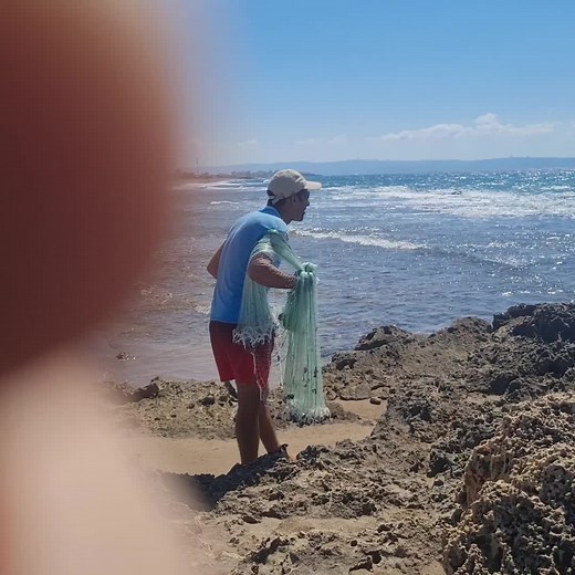 Beach Cleanup: Man Picks Up Plastic Trash