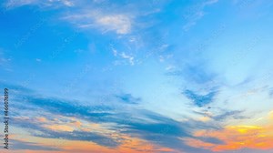 Colorful clouds are changing shapes on the blue sky at sunset.Sky sunset clouds time lapse.