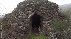 shepherds' typical dry stone house of Sicily architecture in antiquity zoom on detail entrance and false arch (corbel arch) of "cubburo" in Etna Park