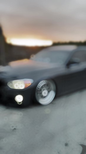 Sleek Modern Sedan Driving at Sunset