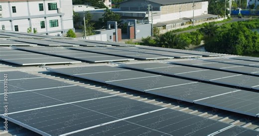 Extensive solar panel array is harnessing renewable energy on a commercial factory roof, focusing on sustainable business practices, eco-friendly infrastructure, and carbon footprint reduction.