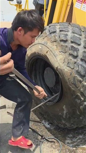 Pry open a road roller tire and pull out the inner tube; there are 108 ways to do it. #RoadRoller...