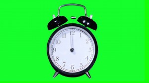 Video footage of an alarm clock ringing at twelve o'clock, shot with green screen background. Professional shot in 4K resolution | Premium Stock Video Footage