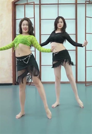 Two beautiful girls dancing together