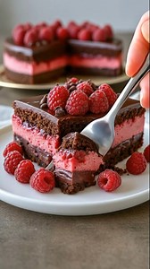 Imagine layers of rich dark chocolate cake, velvety chocolate mousse, and swirls of tangy raspberry sauce—all chilled to creamy perfection and finished with fresh berries and a glossy chocolate drizzle. This Indulgent Raspberry Chocolate Mousse Cake Delight is elegant enough for special occasions yet surprisingly simple to make (and completely no-bake!). It’s a showstopper that wows with every spoonful. Ingredients For the chocolate crust: 2 cups chocolate cookie crumbs (such as Oreo or chocolat