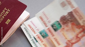 Russian money and passport on a desk. 1000 and 5000 russian money notes and passport cover. Video 4k resolution