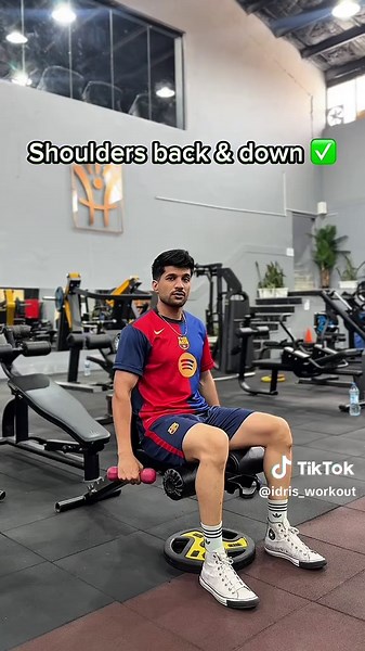 How to Perform the Seated Dumbbell Lateral Raise Correctly ▶ Target Muscle: Middle Deltoid ▶ Equipment: Dumbbells ▶ Difficulty Level: Beginner ▶ STARTING POSITION 1. Sit upright on a flat bench with your feet firmly on the floor. 2. Hold a dumbbell at each side using a neutral grip (palms facing each other). 3. Keep a slight bend in your elbows and maintain the same angle throughout the movement. 4. Brace your core and maintain a neutral spine. 5. Retract and depress your shoulders to stabilize 