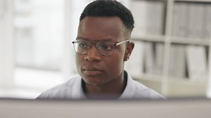 Face, cyber security or serious black man programmer for thinking, coding or UX web designer software. Hacker, thinking or programmer on tech for planning analytics, data analysis or strategy at work