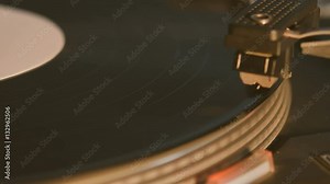 Record player playing an old fashioned vintage vinal record. The needle is being put on the record.