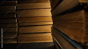 Library stack of old books, slider macro footage in antique shop, bookstore.