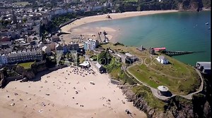 Aerial drone view of the historic Welsh seaside town of Tenby and its twin sandy beaches and medieval fort