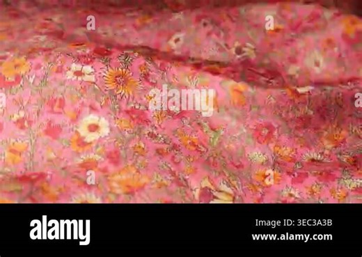 Close up of natural silk fabric with vintage floral pattern in pink and orange shades. The material ripples in the wind creating abstract waves and soft movements Stock Video Footage - Alamy