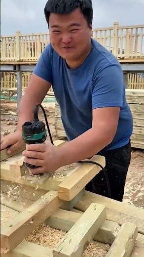 Using a wood router to shape timber boards for making furniture and completing a carpentry project
