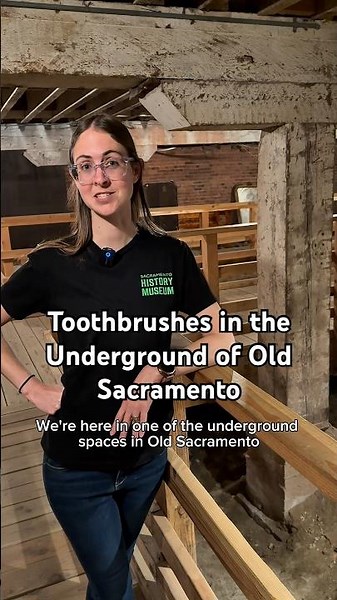 Aly discusses the toothbrushes on display in the underground of Old Sacramento
