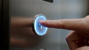 Download Elevator Up Button Pressed in Building Lobby at Night for free