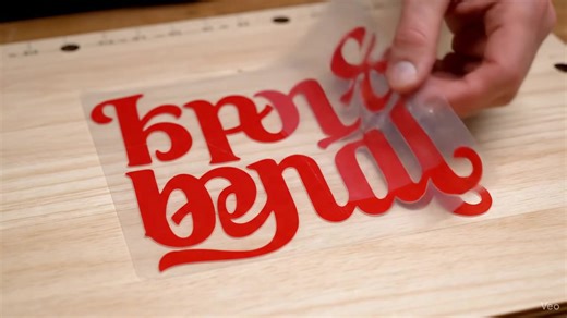 Quick Transfer Tape Technique Lay your weeded vinyl flat. Remove the backing from the transfer tape and press down a small 1-inch strip of the tape along the top edge of the vinyl (this is your hinge). The Smooth Roll: Hold the rest of the tape up and slowly roll it down over the design, smoothing out any air bubbles as you go. Use a scraping tool or Credit card , either or to firmly rub the tape surface, ensuring the vinyl completely sticks to the transfer tape. | H-T Créations