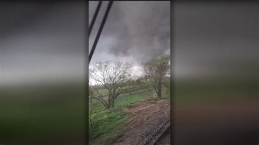 Footage captures moment tornado makes contact with train