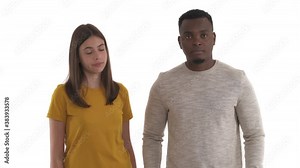 African man staring on something and his Caucasian girlfriend slapping him on the nape. Neck-slap gesture. Isolated on white background