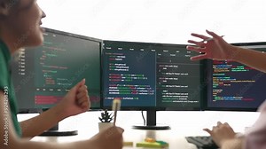 Slow motion back end software developer engineer for computer programming working together on debugging writing computing code, solving complex algorithms display on monitor in office. Burgeoning Stock Video