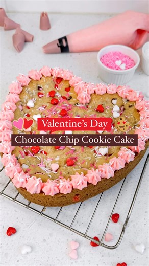 A heart-shaped cookie cake is the ultimate sweet treat for Valentine's Day! ❤️🍪 This is a decadent deep-dish chocolate chip cookie that’s packed with chocolate, candy, and sprinkles, and topped with pink buttercream frosting. What's not to love?! ❤️ Ingredients: 3/4 cup unsalted butter, softened 3/4 cup light brown sugar, packed 1/4 cup granulated sugar 1 egg 2 teaspoons vanilla extract 2 cups all-purpose flour 2 teaspoons cornstarch 1 teaspoons baking soda 1/2 teaspoons kosher salt 1 cup semi-