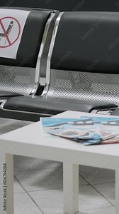Vertical video: Empty hospital reception with nobody sitting on chairs at clinic during covid 19 pandemic. No people in waiting area, medical facility used for consultation appointment during