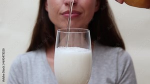 millennial woman drinking beer and eating potatoes chips.girl showing belly waist fat because of alcohol drinks.someone pouring beer into glass in front on face.doubts about eating apple or junk