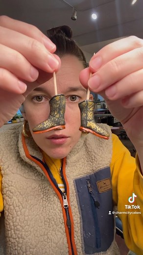 Incredible tiny cowboy boots appreciation post! The devil is in the details, and the cake these ended up going on took that to heart! These were sculpted in gumpaste, and painted with gel food color and luster dust mixed with vodka! #cowboy #pib #thesebootsaremadeforwalking #cowperson #sculptedcake #cake #ccc #duff #duffgoldman #charmcitycakes #minatures #mini #figures | Charm City Cakes