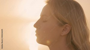 Woman headshot at sunrise by sea