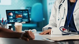 Physician doing a medical consultation with blood pressure monitor, taking pulse and heartbeat measurements for cardiac readings. Providing high quality control and healthcare services. Camera A.