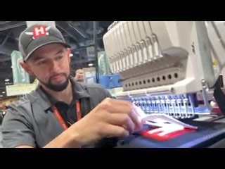 Satisfaction! Texmac sales manager Taro tears the excess foam free on a freshly embroidered 3D puff it done on our #happyjapan embroidery machines. Come see us in action Booth 517 this last day of #graphicspro in Long Beach! | Texmac Happy Embroidery Machines