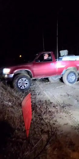 Red Toyota Truck Mudding Adventure Through Muddy Terrain