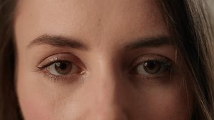 Close up open eyes young Caucasian woman half face vision looking at camera blinking female girl health medicine gaze sight see eyesight lady indoors laser correction cropped view ophthalmology beauty