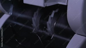 Super slow motion. Male, female hand pulls out Shekel IS bills from money counter machine. Currency, detector counting.