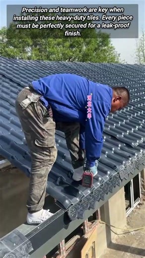 Professional Roofers Installing Interlocking Tiles On A New Home