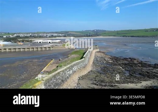 Par, Cornwall, England: DRONE VIEWS: The drone rises over Par Docks harbour wall to reveal Par Sands beach and the town of Par. Par is a fishing port; the harbour was built in the 19th century to transport copper and then china clay Stock Video Footage - Alamy