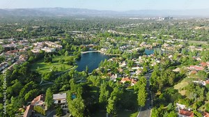 Houses at Calabasas lake, suburban neighborhood Los Angeles, San Fernando Valley, California, USA. Drone footage of the community in the coastal city. High quality 4k footage