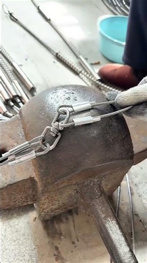 Testing wire rope strength and durability on an anvil in a workshop