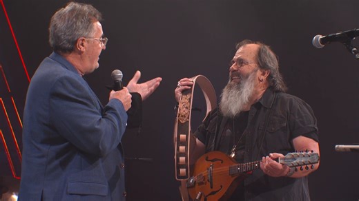 4.7M views · 120K reactions | ICYMI: Vince Gill surprised Steve Earle with an invitation to become the newest member of the Grand Ole Opry by presenting him with a custom guitar strap commemorating 100 years of the Opry! Watch the full moment below. We're thrilled to welcome you to the family, Steve ♥️ | Grand Ole Opry | Facebook
